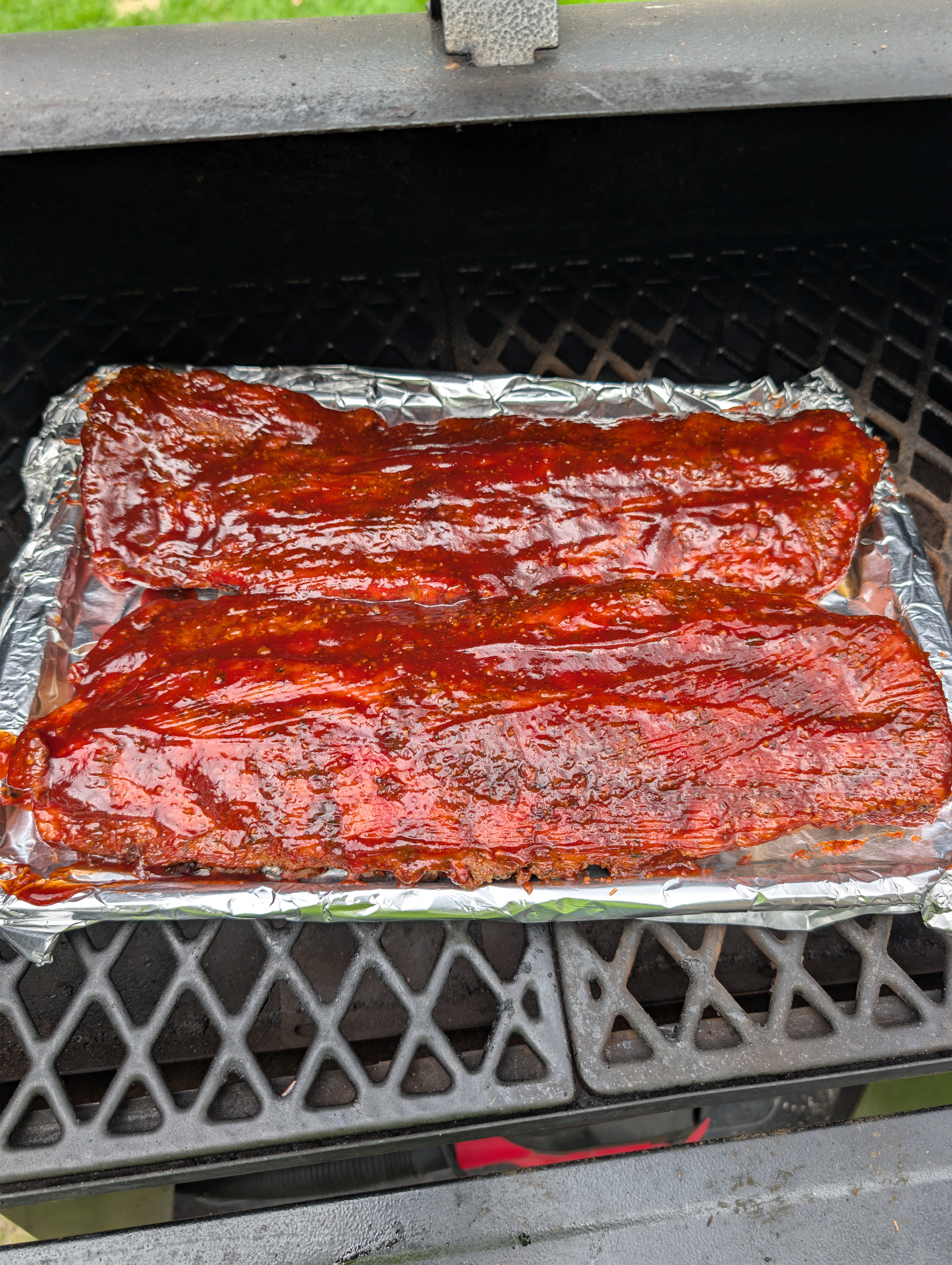 Ribs sauced during the final glaze phase on the grill