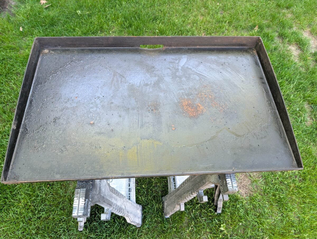 Blackstone griddle surface showing heavy rust and flaking seasoning before restoration