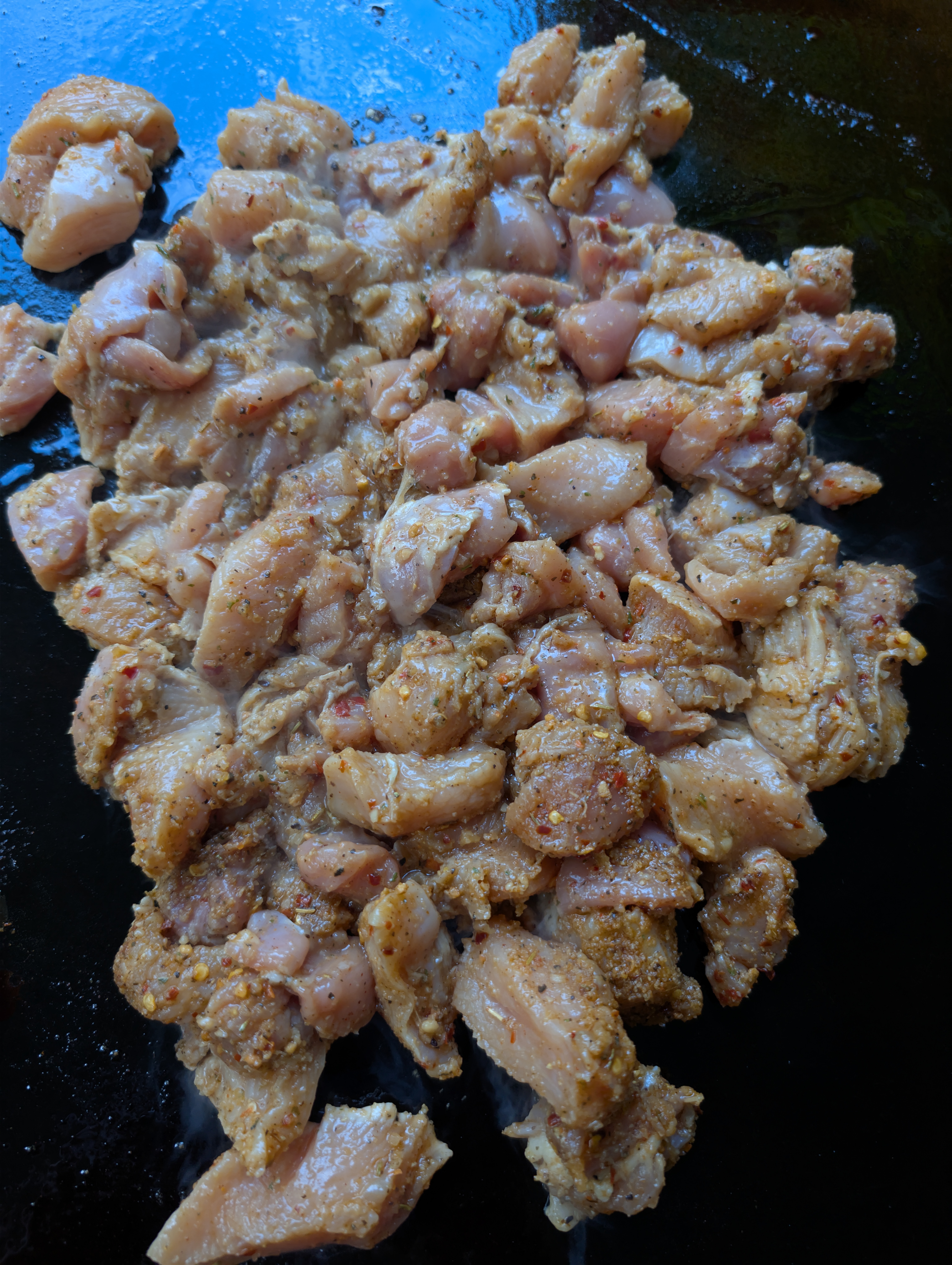 Chicken chunks coated in Kickin' Chicken, Caribbean Jerk, and Italian dressing marinade, ready for the griddle