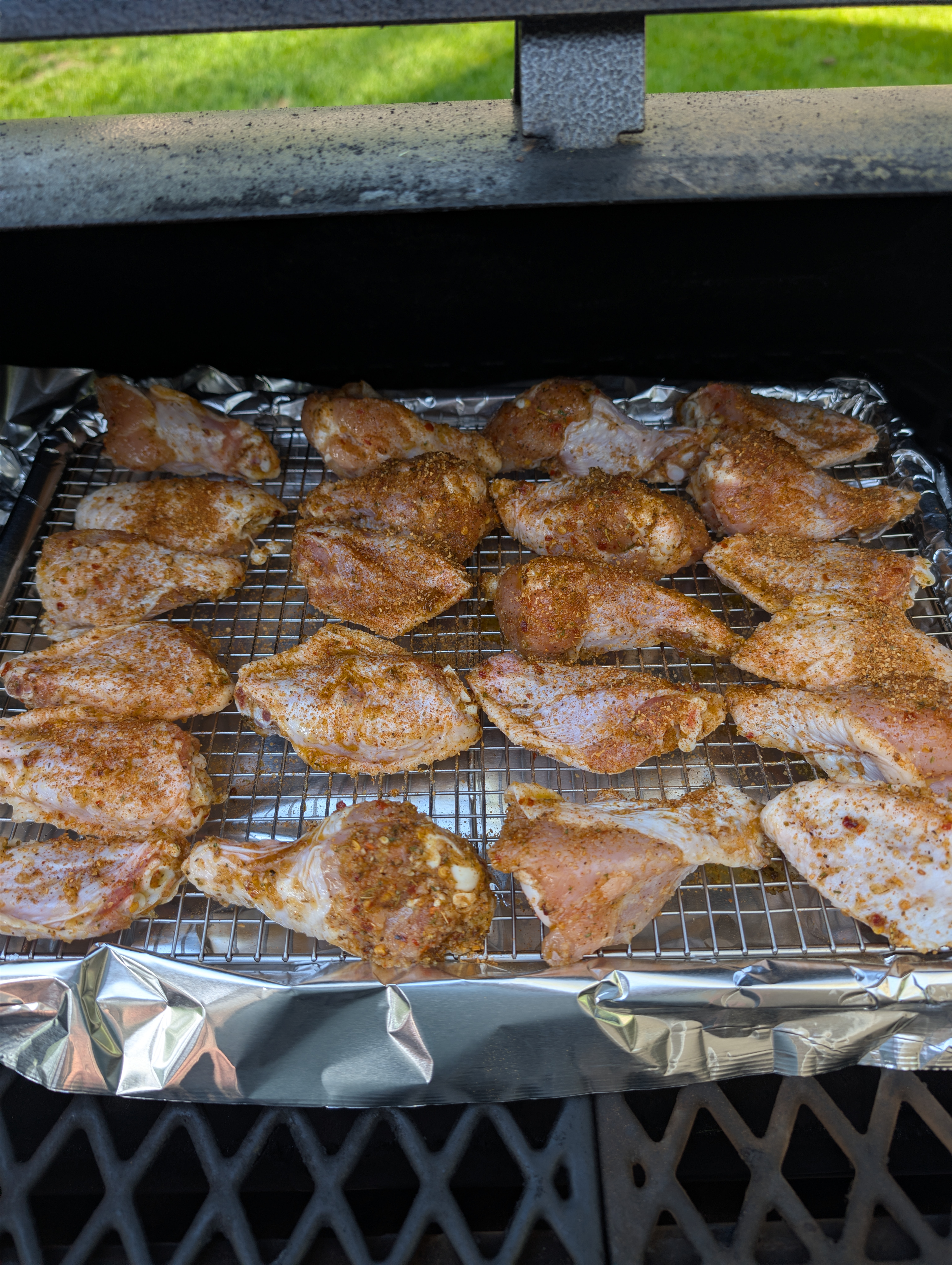 Seasoned chicken wings arranged on the Ultra Cuisine airflow rack before smoking